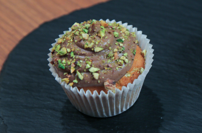 Cupcake de caramelo salgado, cobertura de creme inglês e cacau com pistache e mirtilo | Band Receitas